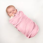Baby wrapped in flannel receiving blanket