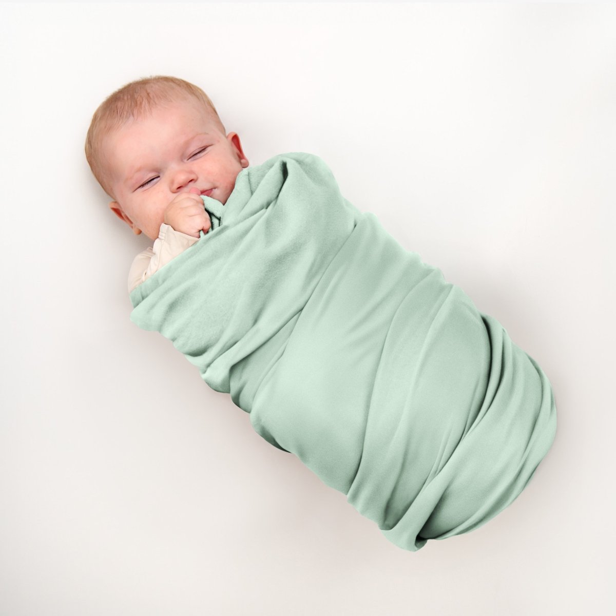 Baby wrapped in flannel receiving blanket
