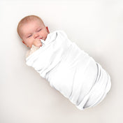 Baby wrapped in flannel receiving blanket