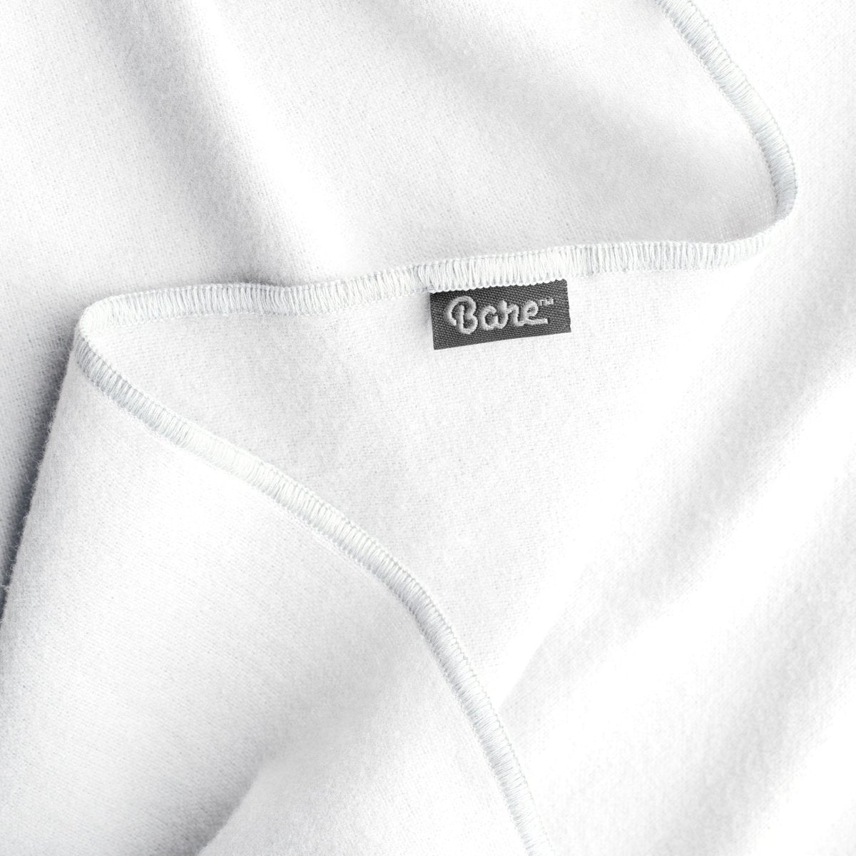 Up close image flannel receiving blanket showing tag