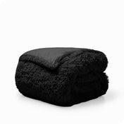 A black shaggy duvet cover folded neatly