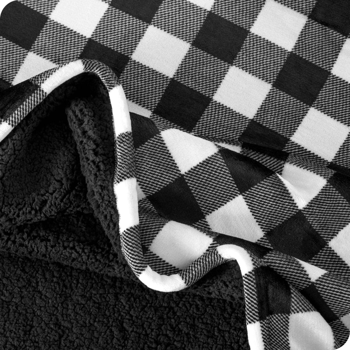 Close up of sherpa blanket showing texture of velvety soft side and sherpa backing