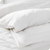 Close in view of comforter showing baffle structure and tie down loops for duvet cover