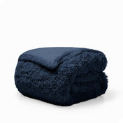 A dark blue shaggy duvet cover folded neatly