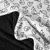 Close up of sherpa blanket showing texture of velvety soft side and sherpa backing