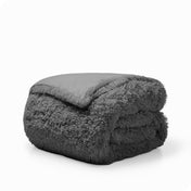 A grey shaggy duvet cover folded neatly