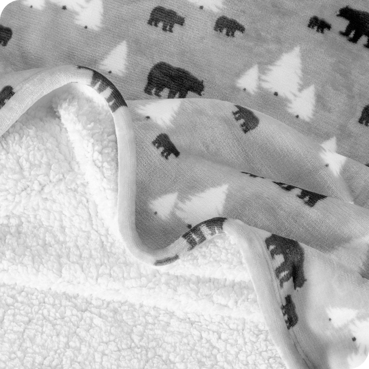 Close up of sherpa blanket showing texture of velvety soft side and sherpa backing
