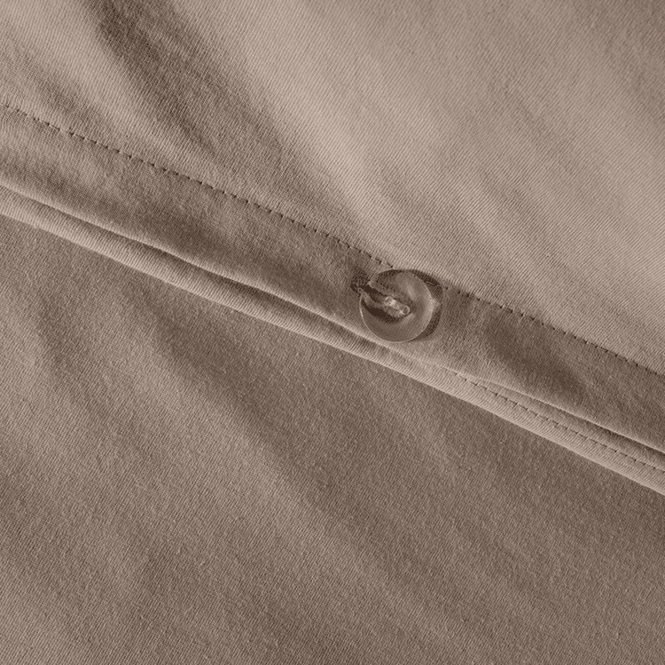 Closeup of taupe Organic Cotton Jersey Duvet Cover Sham Set fabric with snap button closure