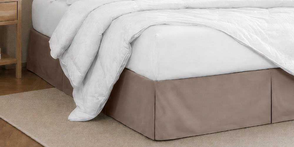 Close-up of a bed with a white ruffled bed skirt