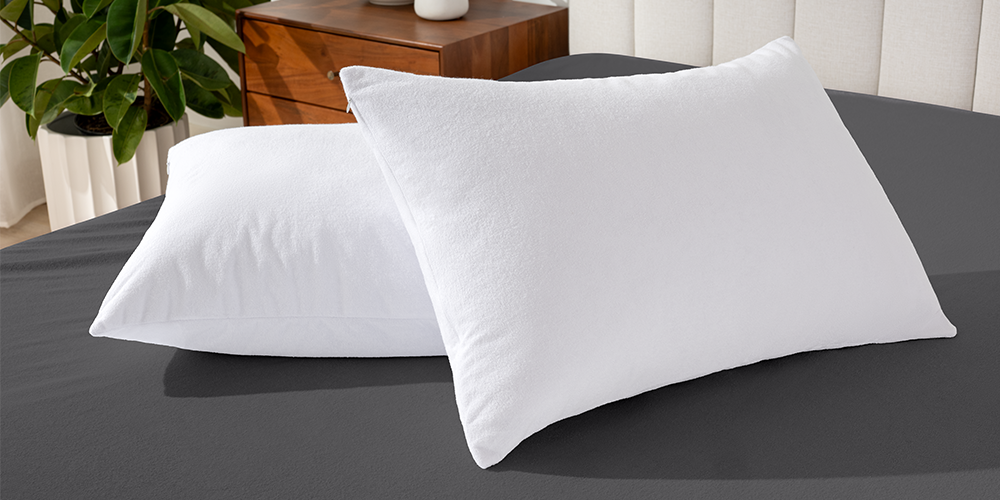 Two pillows covered with white Cotton Terry Pillow Protectors