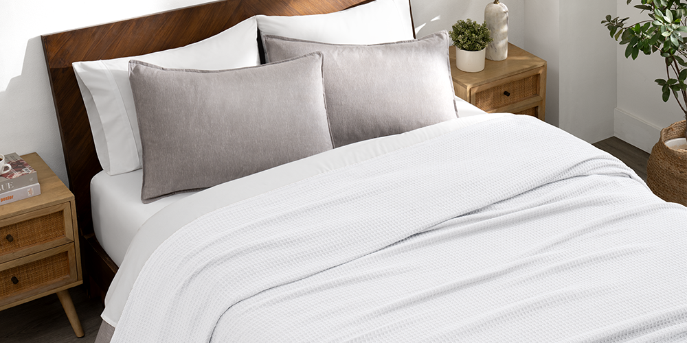 Bed with a tan waffle blanket