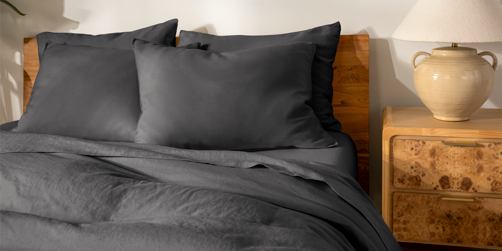 Bed styled with gray European Linen Bedding Bundle in a bedroom