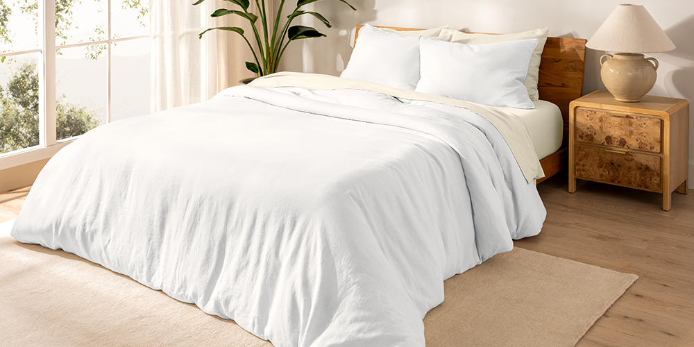 Bed styled with white European Linen Duvet Cover Set in a bedroom with wood nightstand