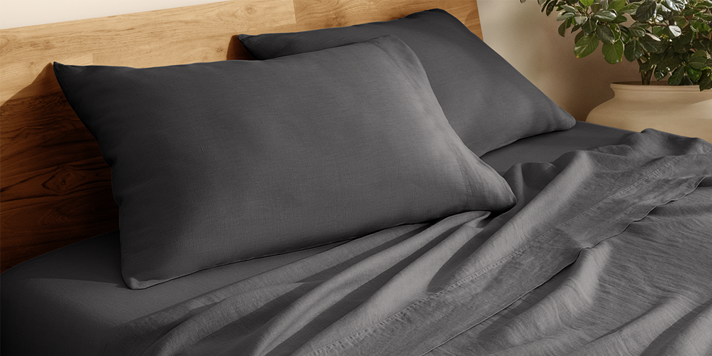 Bed styled with dark gray European Linen Sheet Set, closeup
