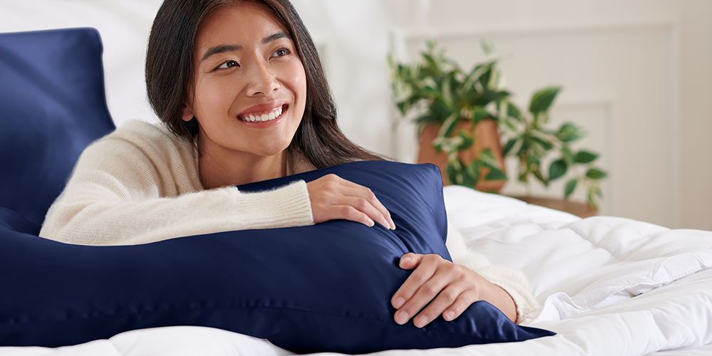 Woman lying in bed on a white mulberry silk body pillowcase