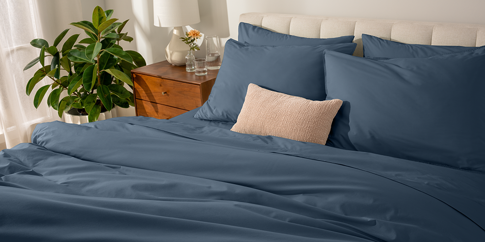 Bed styled with navy blue Organic Cotton Percale Bedding Bundle