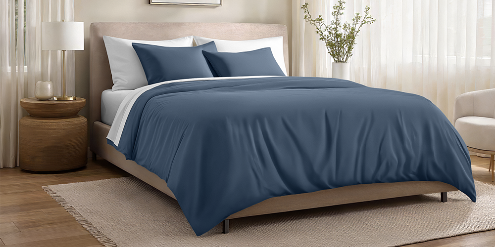 Bed styled with slate blue Organic Cotton Sateen Duvet Cover Set and wood bed frame