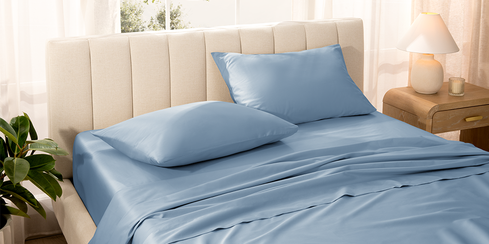 Bed styled with light blue Organic Cotton Sateen Pillowcase Set