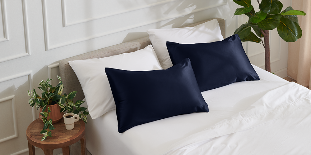 Close-up of a navy satin pillowcase set on a nightstand
