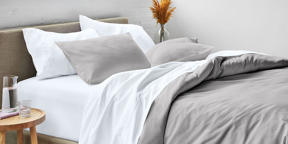 Bed styled with white Ultra Soft Pillow Sham Set and gray blanket