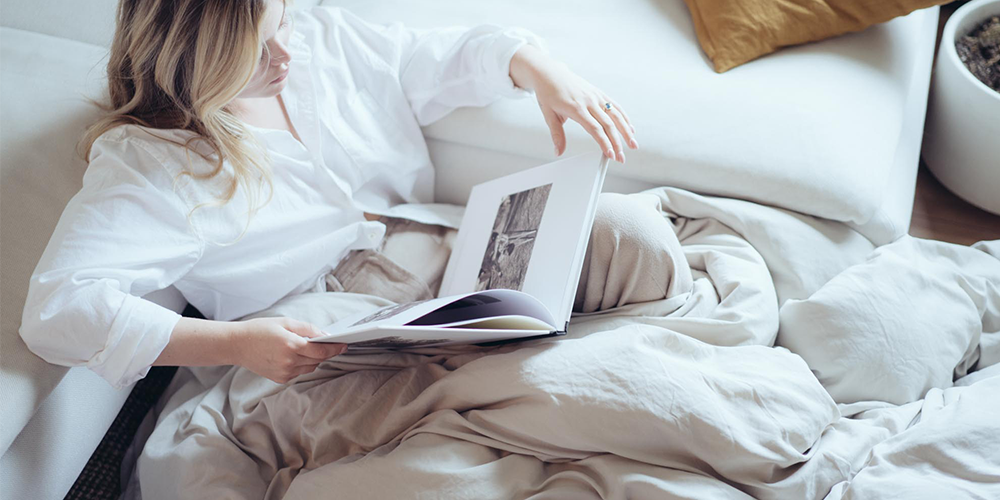 Woman relaxing in bed with cream Ultra Soft Washed Duvet Cover Set, closer view