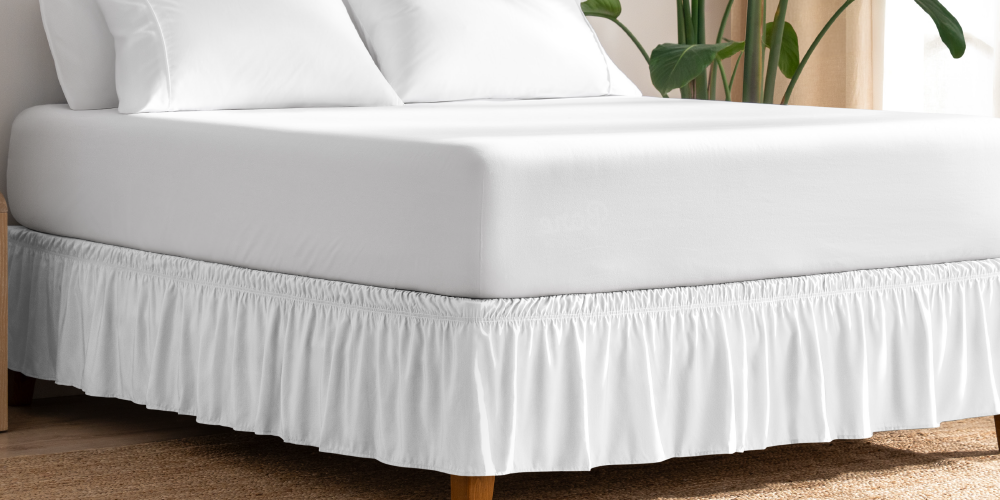 Bed with a white ruffled wrap-around bed skirt