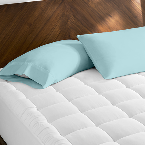 Bed corner with white Cotton Top Mattress Pad and teal pillow