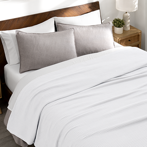 Bed with a gray waffle blanket