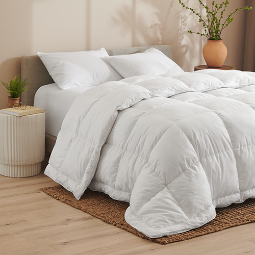 Neatly made bed with a white down comforter