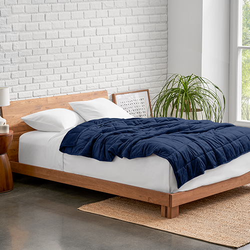 Bed with a navy minky fleece weighted blanket