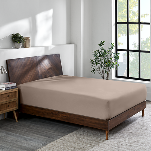 Closeup of taupe Organic Cotton Jersey Fitted Sheet on bed corner