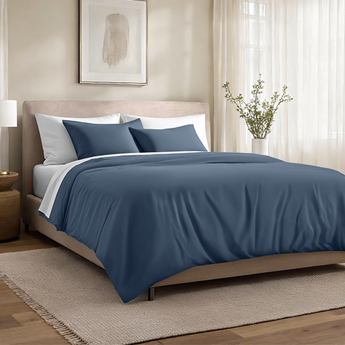 Bed styled with slate blue Organic Cotton Sateen Duvet Cover Set, closer view