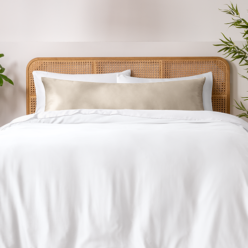 Bed with a white bamboo pillowcase and body pillow