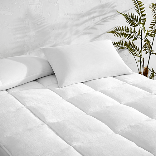 Bed corner with white Reversible Mattress Pad
