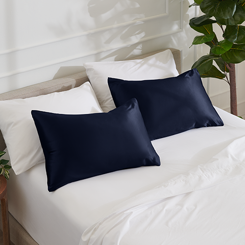 Bed with a navy satin pillowcase set