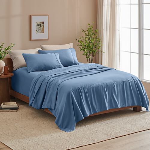 Bed styled with blue Ultra Soft 22 Inch Pocket Sheet Set, closer view