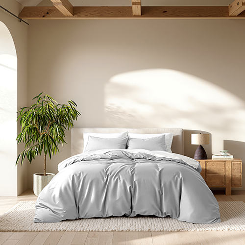 Bed styled with light gray Ultra Soft Duvet Cover Set, plant nearby