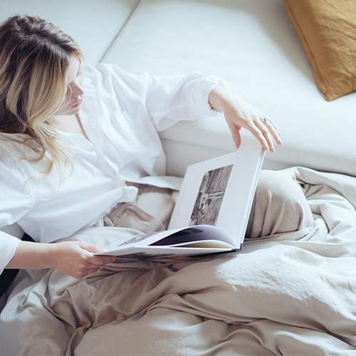 Woman reading in bed with cream Ultra Soft Washed Duvet Cover Set