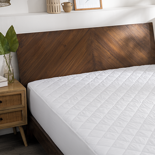 Bed styled with white Wrap Around Bed Skirt and wood bed frame