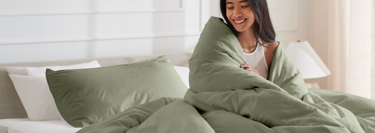 Woman wrapped in a green duvet