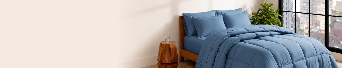 Bedroom scene with blue bedding and a nightstand