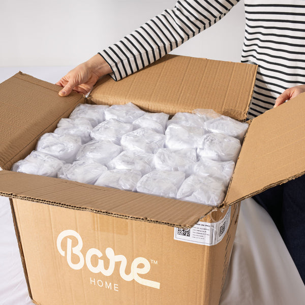 Person opening a box of bulk blankets