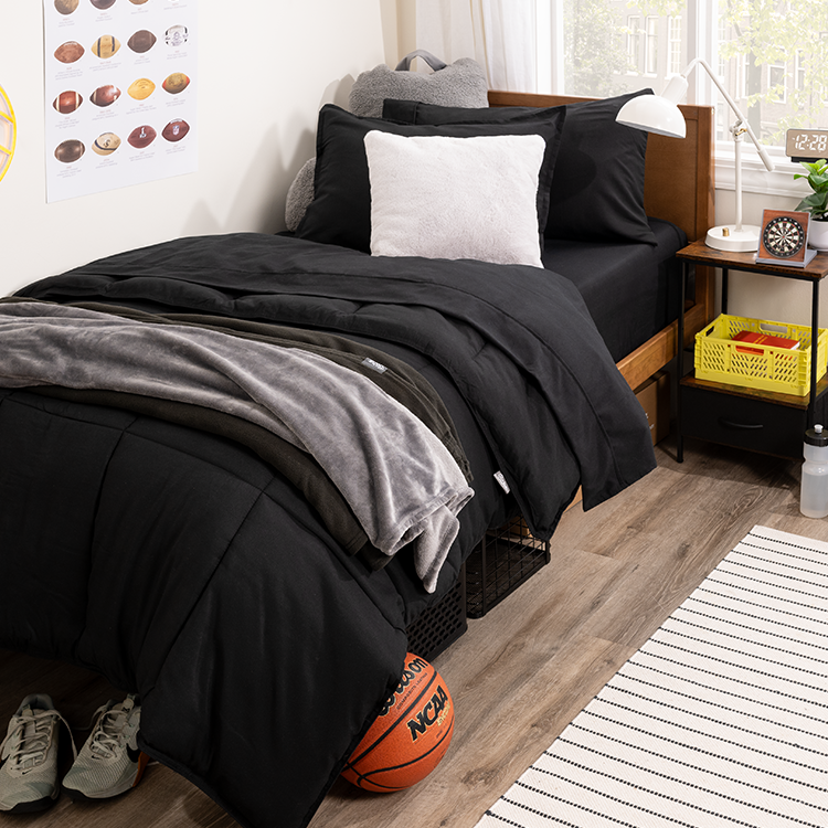 Bed styled with dark navy Dorm Ready Bundle