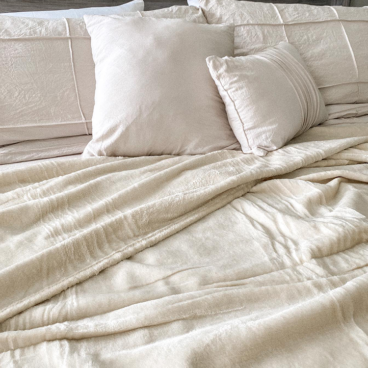 Bed styled with white Microplush Fleece Sheet Set, closeup