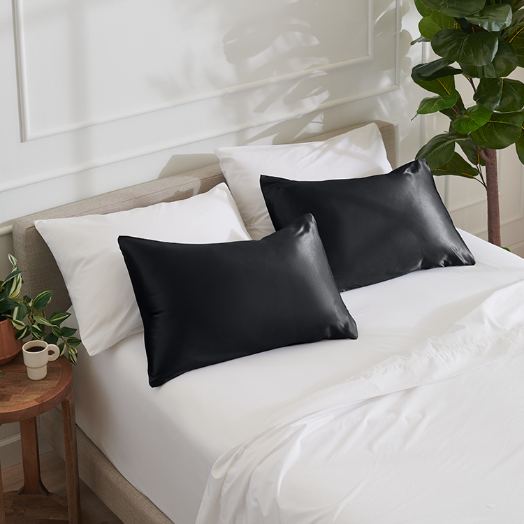 Bed with a navy mulberry silk pillowcase set
