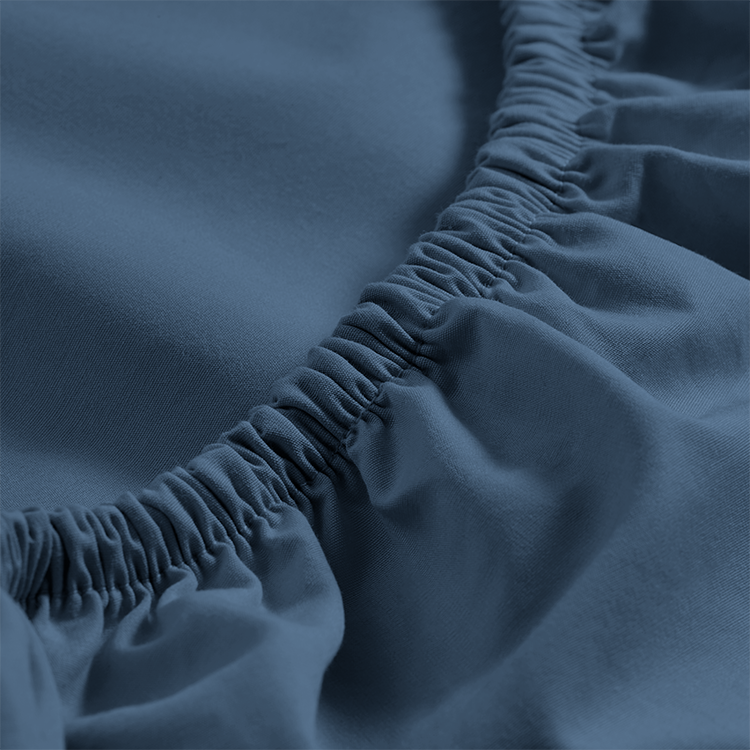 Closeup of navy blue Organic Cotton Percale Fitted Sheet on a mattress corner
