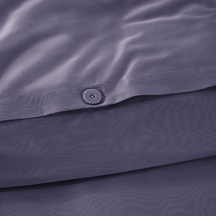 Closeup of dark navy Organic Cotton Sateen Duvet Cover Set fabric with button closures