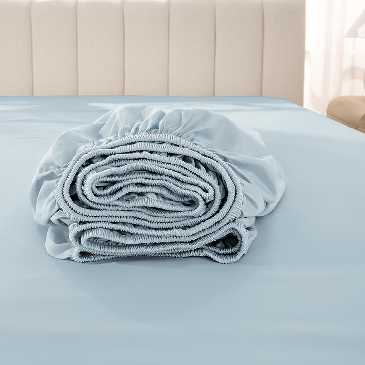 Rolled up light blue Organic Cotton Sateen Fitted Sheet