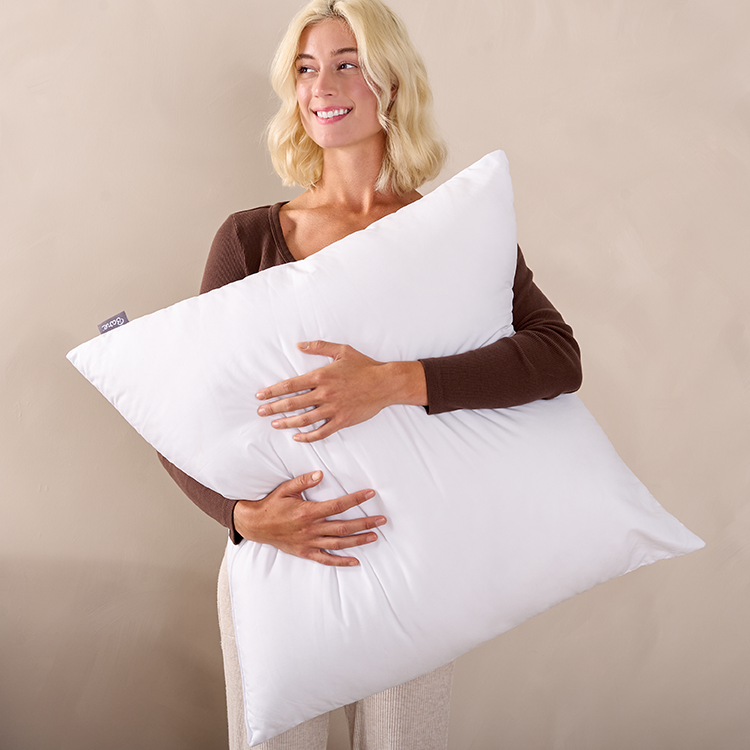 Woman holding a white Pillow Insert pillow