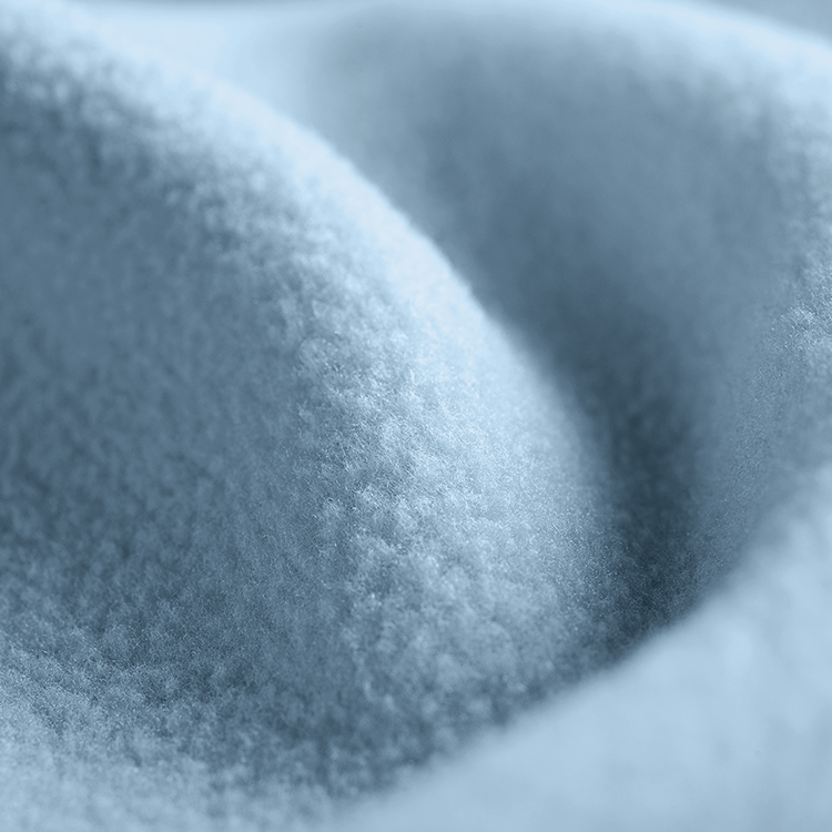 Closeup of light blue Polar Fleece Blanket fabric texture with plush folds